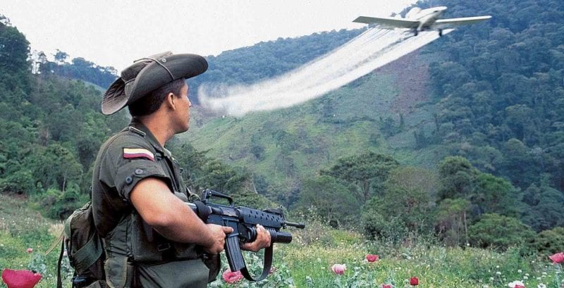 Soldier stands guard during aerial fumigation in Colombia